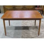 A Scandinavian teak extending dining table of rectangular form with moulded and two additional