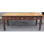 A vintage oak ex school table fitted with three frieze drawers raised on square cut and slightly