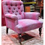 A late Victorian drawing room chair with reupholstered finish, button back, rolled arms, turned