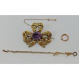 Victorian yellow metal amethyst mourning brooch of bow form, with glazed compartment verso