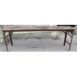 A vintage bespoke work table of rectangular form with rustic pine top raised on angle iron