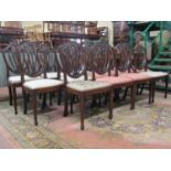 A set of fourteen (2+12) shield back mahogany dining chairs with wheatear, urn and other detail,