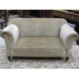 An Edwardian two seat single drop end sofa with traditional rolled arms and upholstered finish