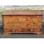 A 19th century pine box with hinged lid over two drawers and bracket feet, 107 cm wide x 50 cm