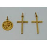 Pair of 9ct cross pendants - 2.7g and a further yellow metal pendant depicting a water carrier (