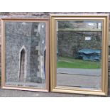 Two contemporary gilt framed wall mirrors of rectangular form with bevelled edge plates, varying
