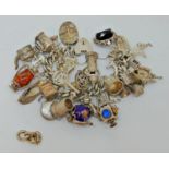 Good silver curb link charm bracelet with heart padlock clasp, hung with a collection of novelty