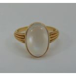 9ct cabochon moonstone ring with banded shoulders, maker 'BJ', London 1980, size L/M, 3g