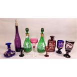 A collection of 19th century coloured glass including an amethyst bottle shaped decanter, two