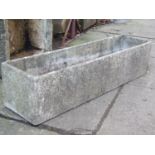 A reclaimed shallow garden trough of rectangular form, with simulated textured/rough hewn finish,
