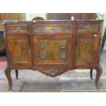 A small breakfront sideboard fitted with a T shaped arrangement of five drawers flanked by two