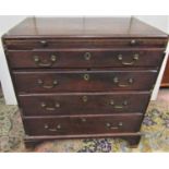 A small George III caddy top chest of four long drawers with brush slide, raised on bracket