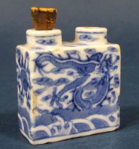 A 19th century oriental blue and white twin aperture scent bottle with dragon detail, with blue