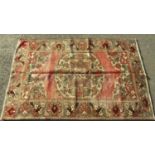 Old Persian Bakhatiar rug with central floral medallion upon a washed red ground, 200 x 130cm (worn)