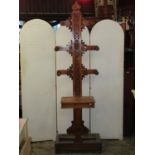 A Victorian oak tree shaped hall stand with turned pegs and repeating carved flowerhead detail