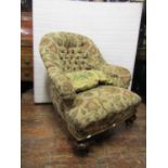 A Victorian drawing room chair on turned mahogany supports, recently re-upholstered in a button back