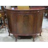 An Edwardian mahogany demi-lune freestanding side cupboard, the top with gadroon moulded outline