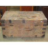 A 19th century pine trunk with hinged lid, strap reinforced corner fittings, two locks, drop side