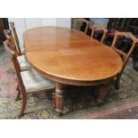 A Victorian oak D-end extending dining table with two additional leaves, raised on four fluted