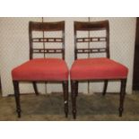 A set of four Regency mahogany dining chairs with moulded and reeded bar backs, over upholstered