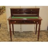 A 19th century mahogany desk/writing table with raised back incorporating four small drawers over