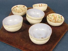 A set of six oriental eggshell porcelain bowls with polychrome floral decoration mounted onto a