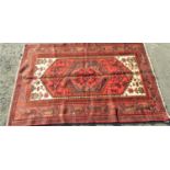 Good Persian Zanjan rug with central blue and red floral medallion and further still lives upon a