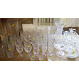 A large collection of glassware including cut glass tumblers, stem wines, flutes, liquors,