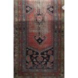 19th century Persian runner with blue medallion decoration upon a washed red ground, 420 x 95cm (