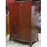 A dwarf mahogany bow fronted linen cupboard in the Georgian style enclosed by a pair of full