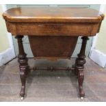 A good quality Victorian burr walnut games/sewing table, the shaped top with floral marquetry inlay,