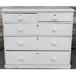 A Victorian pine bedroom chest of two short over three long graduated drawers with later painted