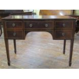 An Edwardian mahogany ladies writing desk fitted with five frieze drawers, to a central kneehole,