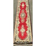 Persian Kirman full pile runner with central blue floral medallion and further floral trails upon