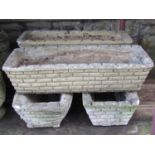 Four similar reclaimed flower troughs/planters of rectangular tapered form, with simulated stonewall