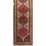 Good quality Persian full pile runner with five medallion decoration upon an ivory ground, 290 x