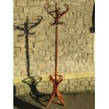 A stained beechwood Bentwood floorstanding hat/coat stand and small Edwardian wall cabinet