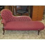 A Victorian style chaise lounge with upholstered repeating lattice and fleur-de-lys pattern seat and
