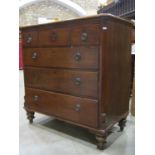 A Georgian walnut bedroom chest of three short over three long graduated drawers flanked by canted