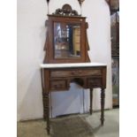 A 19th century walnut dressing table, the raised swing mirror back with rectangular plate beneath