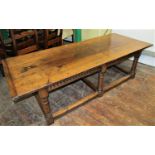 A low occasional table in the old English style, the plank top with cleated ends, raised on six
