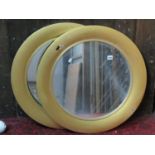 A pair of circular wall mirrors with painted frames, 68 cm diameter