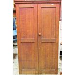 A wall mounted oak side cupboard enclosed by a pair of full length twin panelled doors, the interior