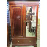 An Edwardian mahogany wardrobe with inlaid satinwood banding and enclosed by a pair of three quarter