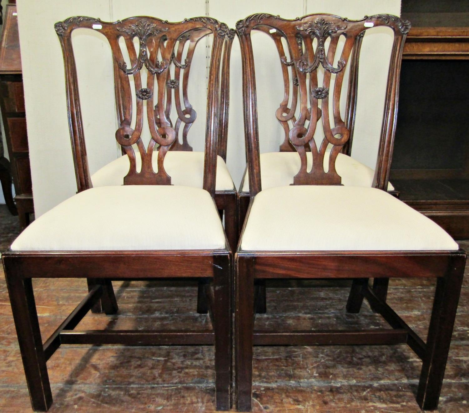 A set of six (2+4) good quality mahogany dining chairs with carved and pierced splats, set beneath