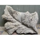 A carved natural stone architectural/garden ornament in the form of a leaf/foliage, 70 cm x 54 cm
