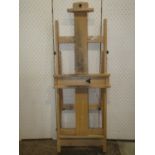 A floorstanding folding beechwood and adjustable artists studio easel