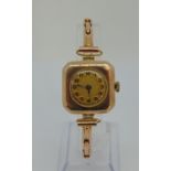 1920s/30s 9ct dress watch, textured gilt dial and black enamel Arabic numerals, 26mm case, upon a