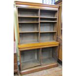 A Victorian oak two sectional bookcase enclosing adjustable shelves beneath a moulded pediment,