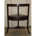 A Georgian mahogany freestanding three tier corner washstand fitted with one real and two dummy